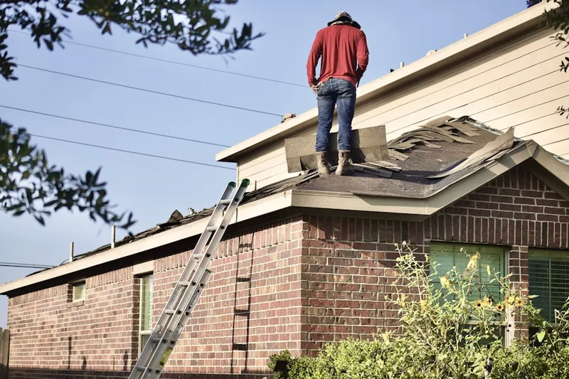 Professional roofer working on a residential roof in The Ponderosa